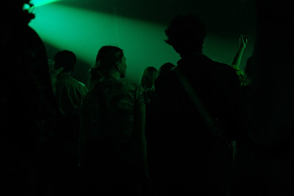 a group of people standing in a dark room