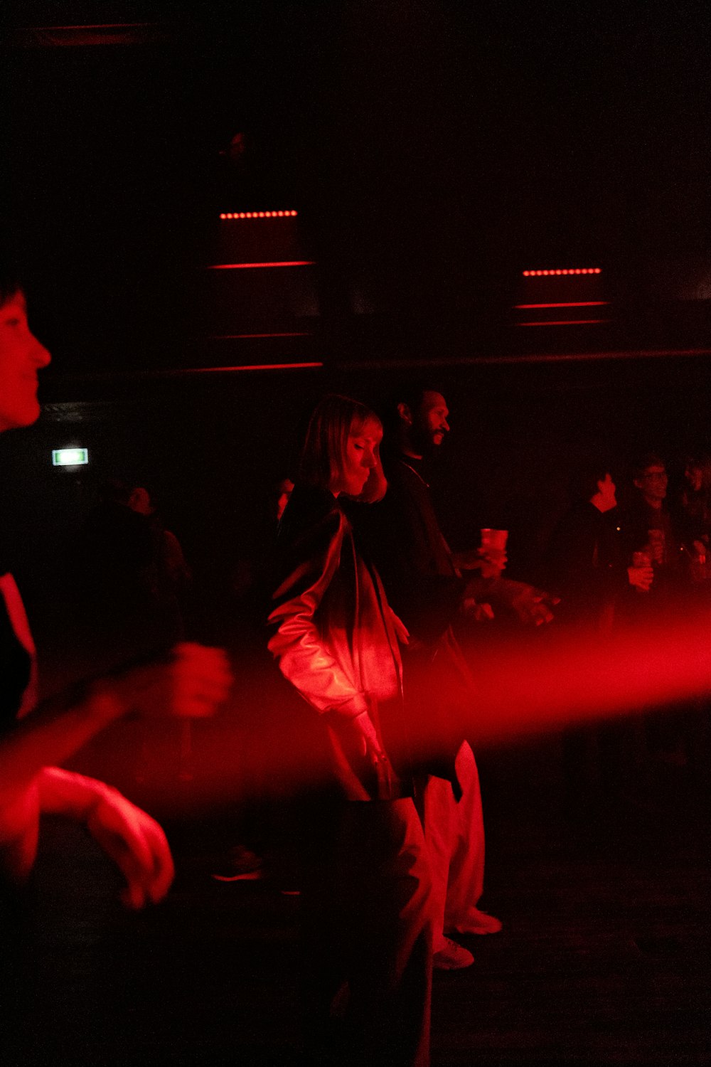 a group of people dancing in a dark room