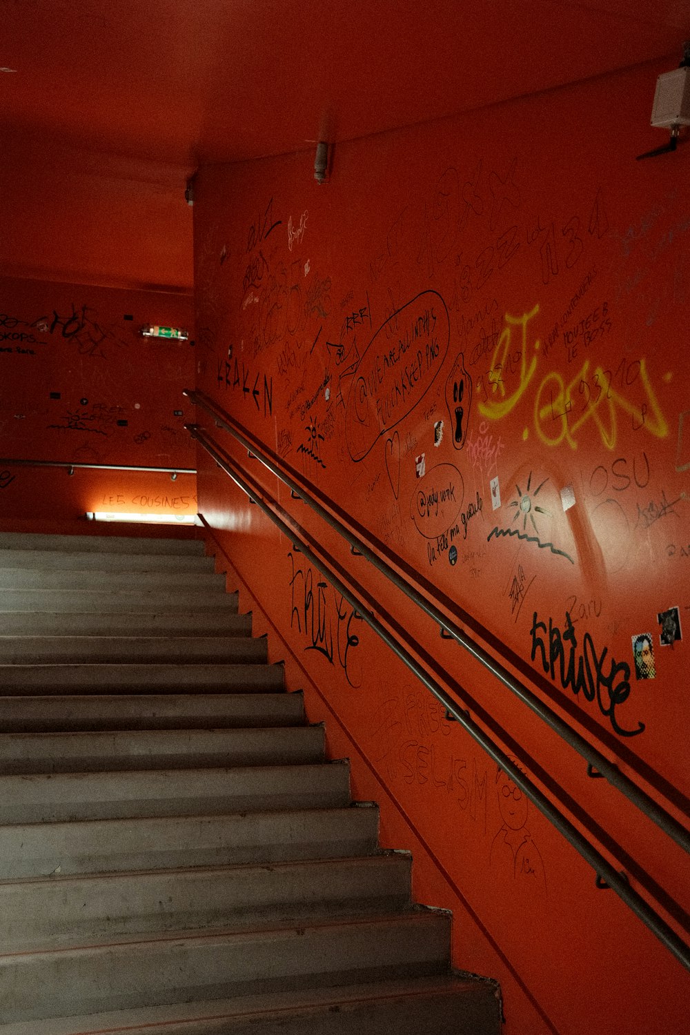 a stairwell with graffiti on the walls and stairs