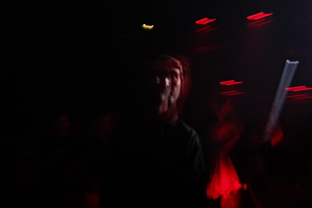 a group of people standing around a dark room