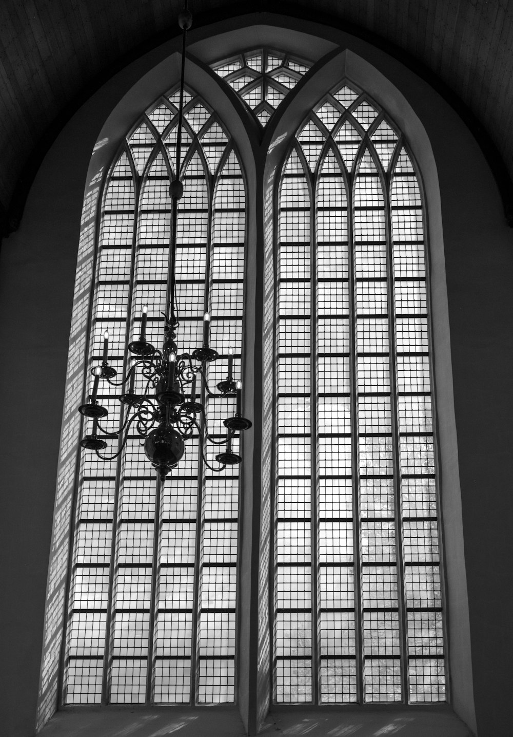 a chandelier hanging in front of a large window