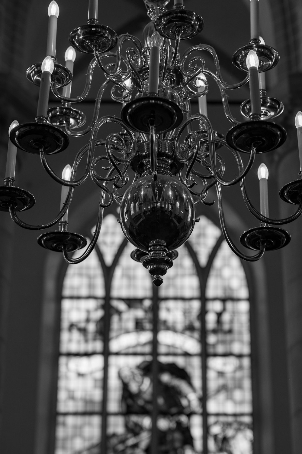 a chandelier in front of a stained glass window