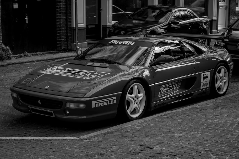 a black and white photo of a sports car