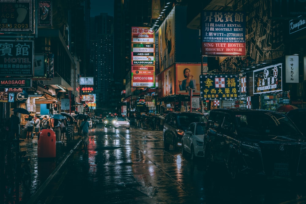 a city street at night with a lot of signs