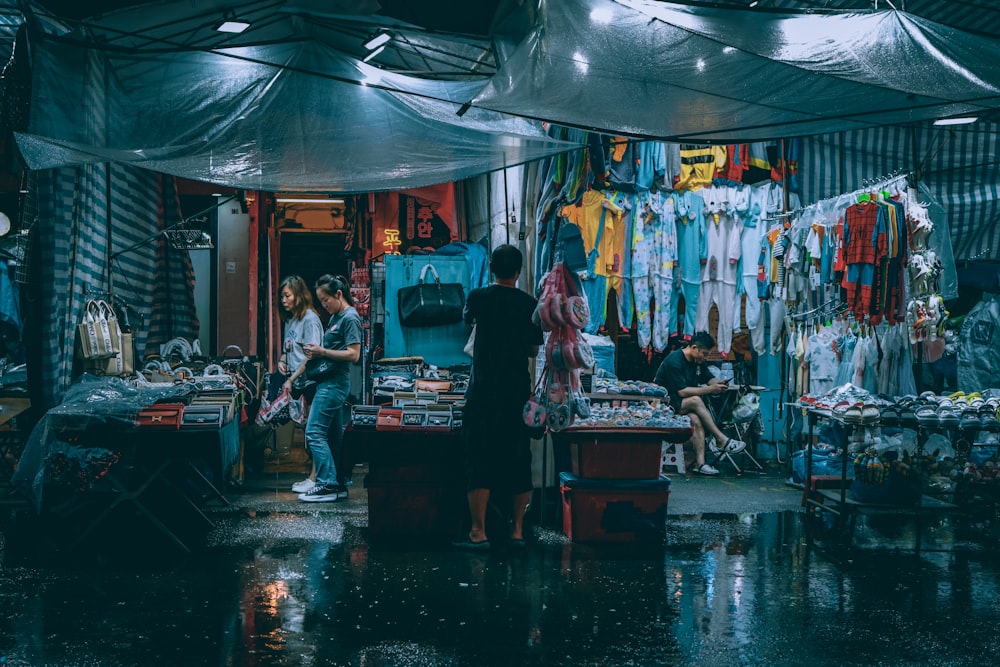 a group of people standing in front of a store