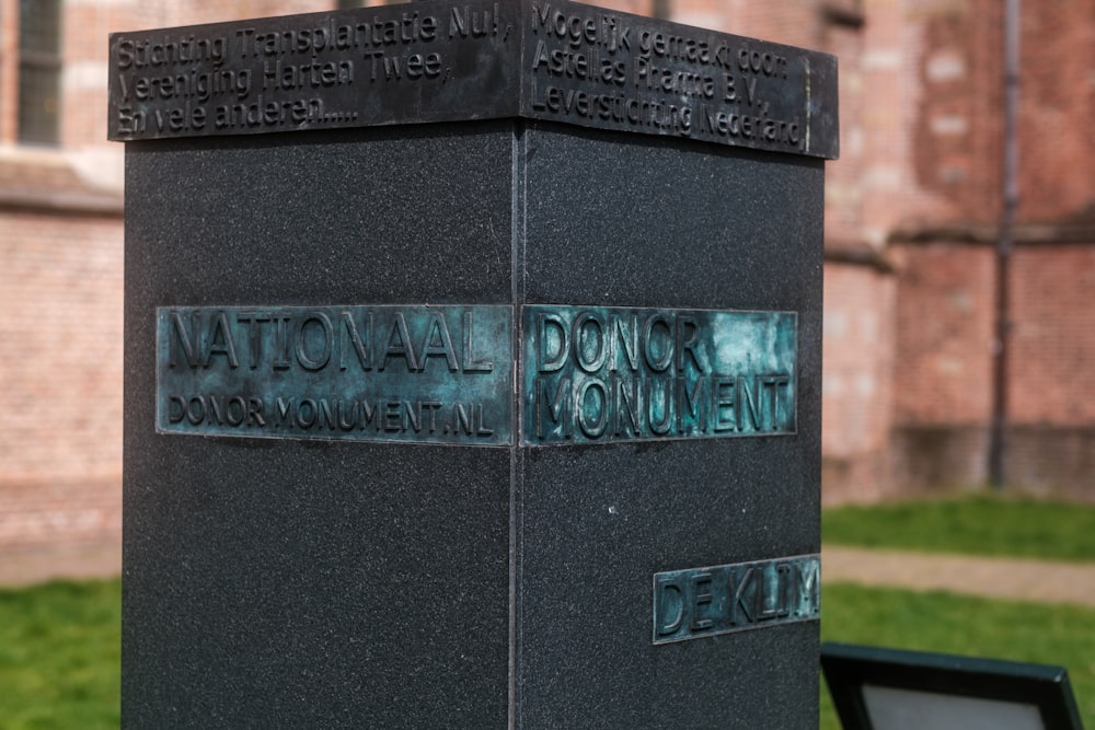 a monument in front of a brick building