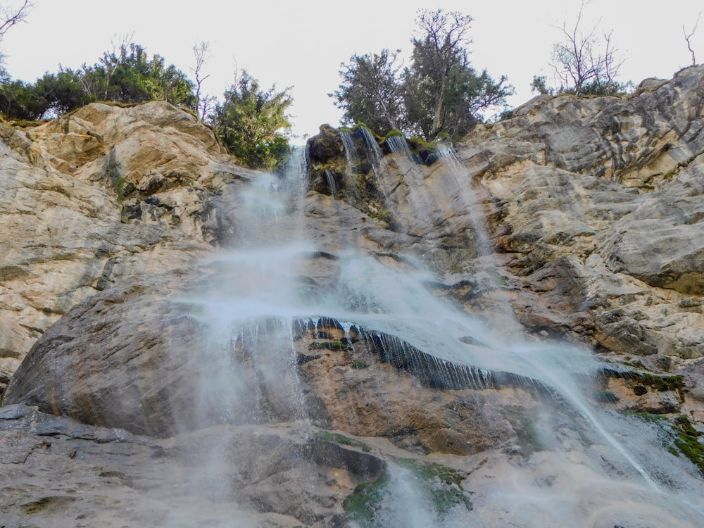 a very tall waterfall with lots of water coming out of it