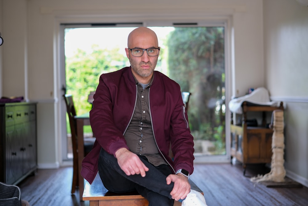 a man sitting on a chair in a living room