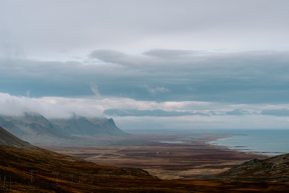 a mountain range with a body of water in the distance