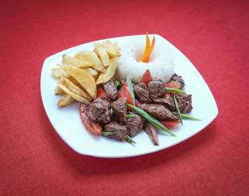 a white plate topped with meat and veggies