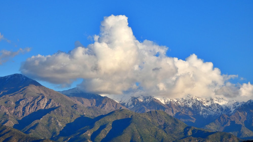 a mountain range with a cloud in the sky