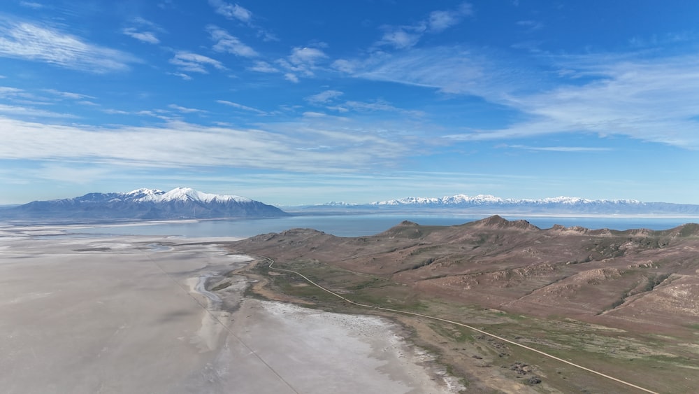 an aerial view of mountains and a body of water