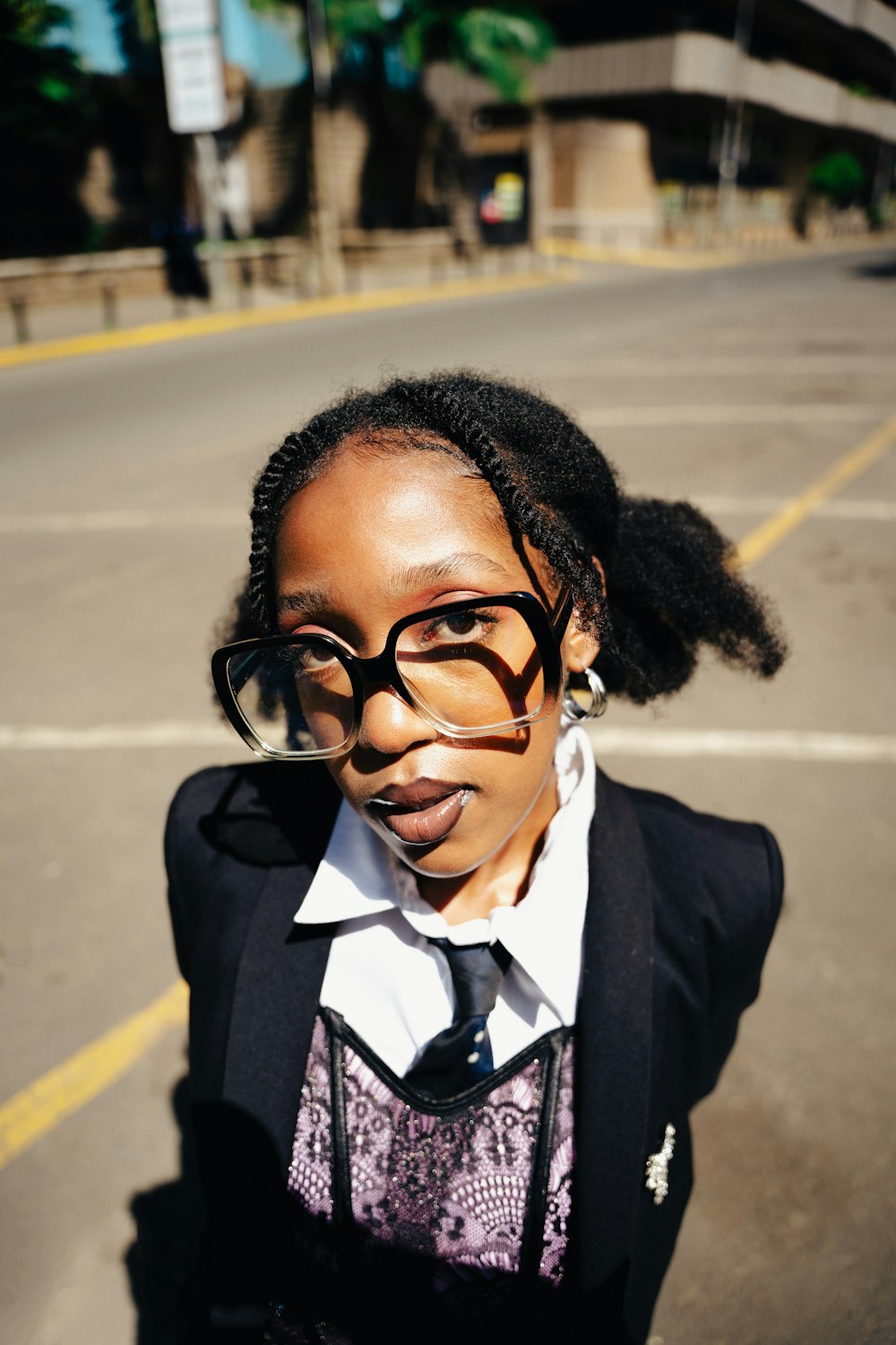 a young woman wearing glasses and a tie