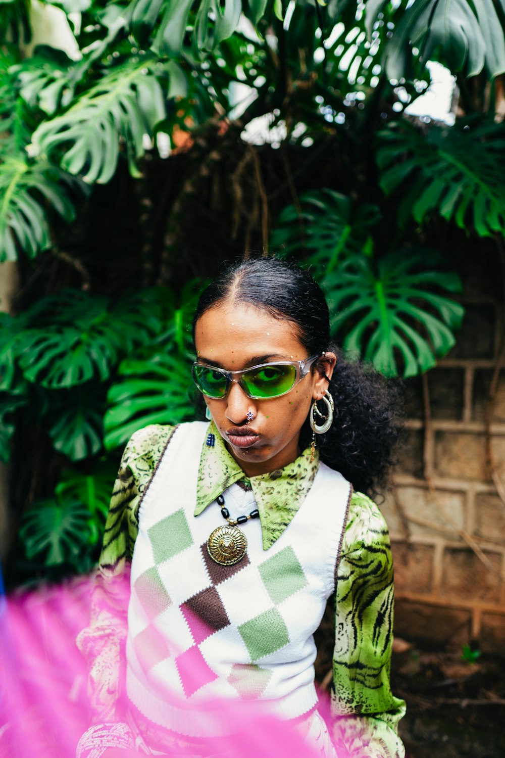 a woman wearing sunglasses and a green shirt