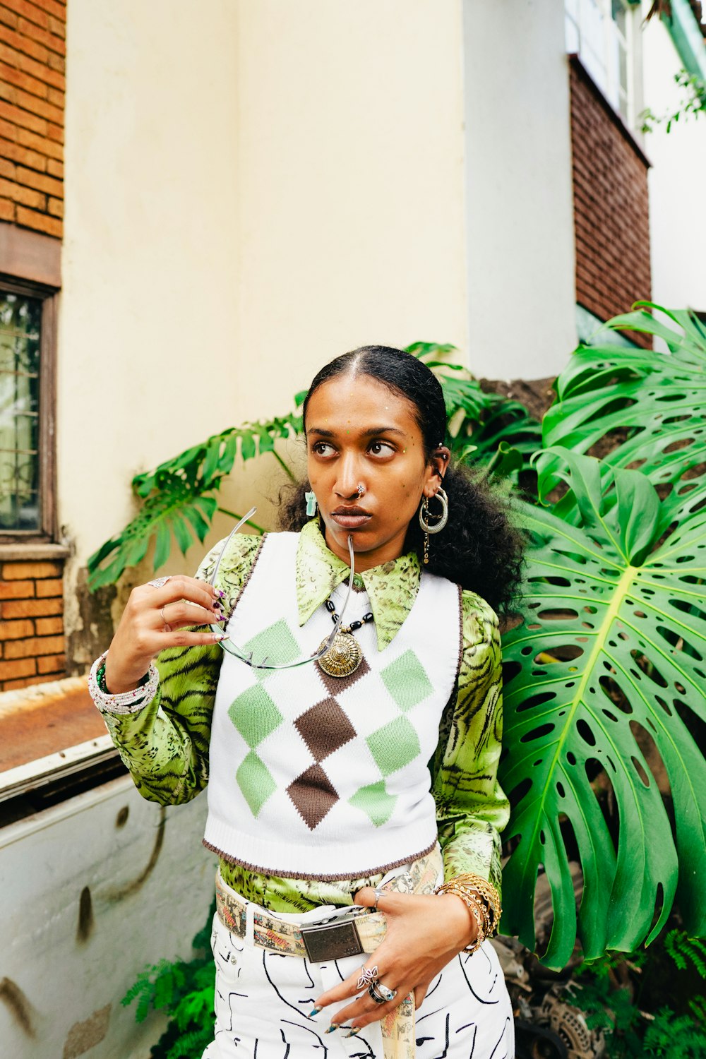 a woman standing in front of a plant