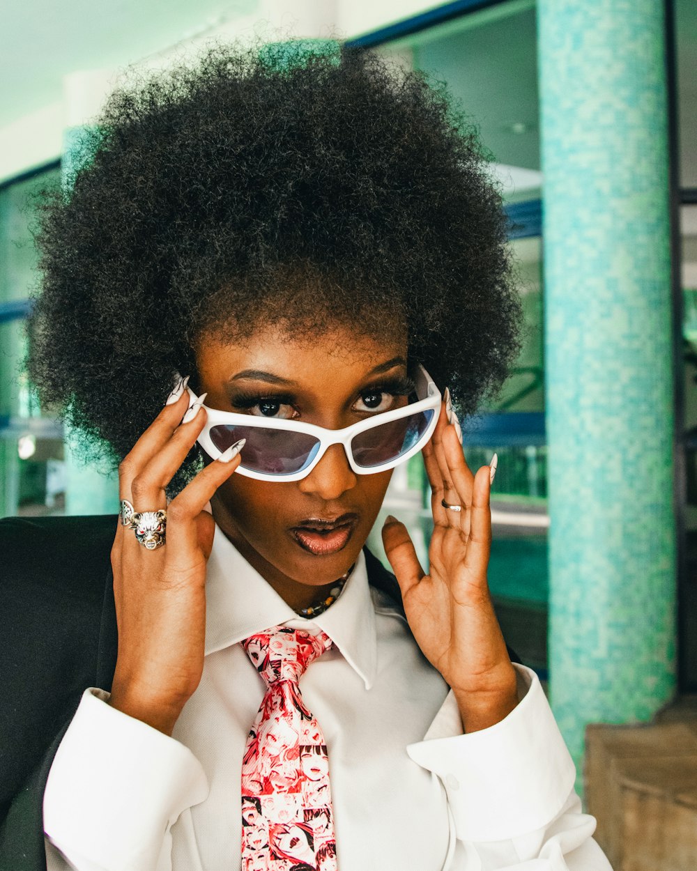 a woman wearing a tie and sunglasses