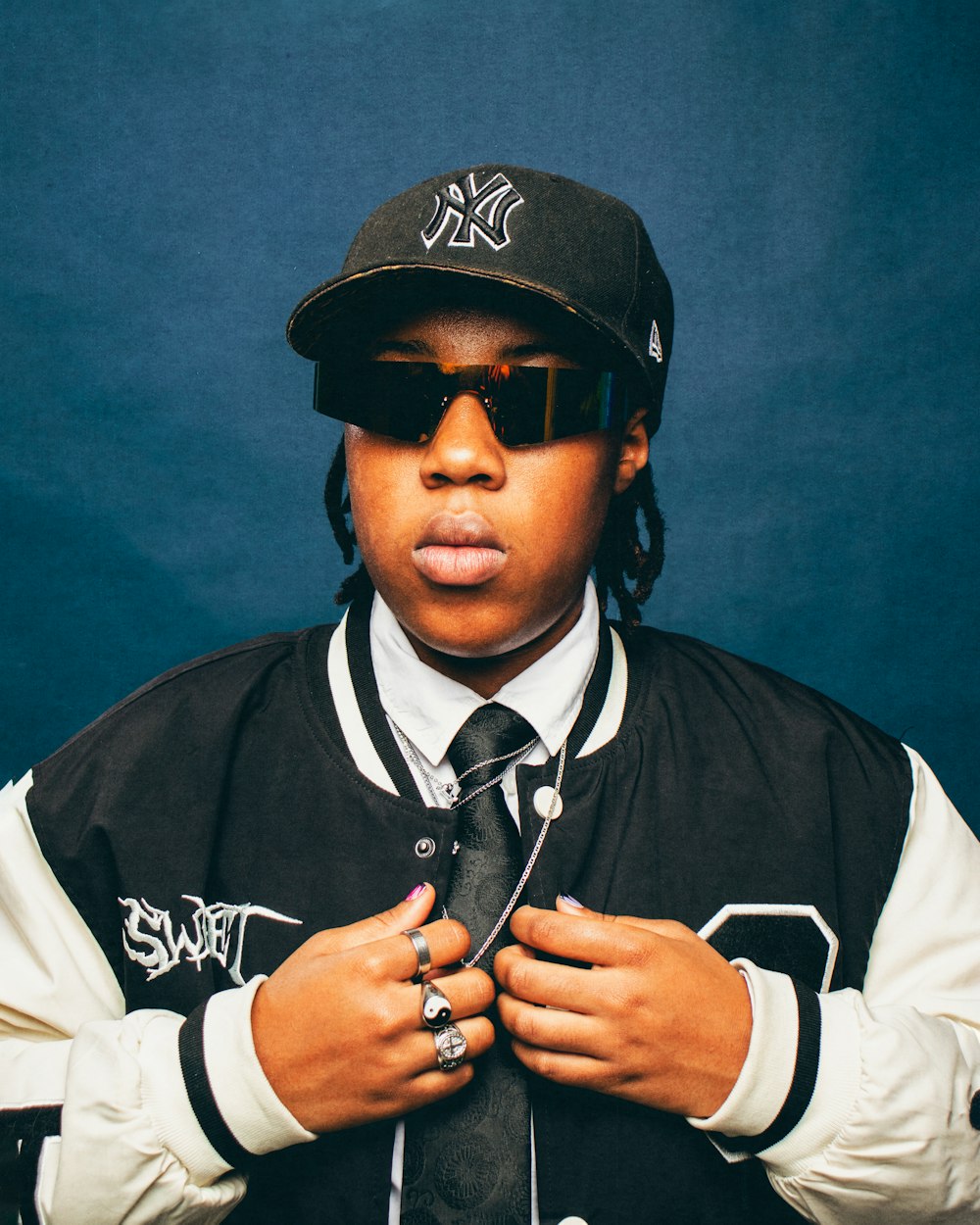 a young man wearing a hat and sunglasses