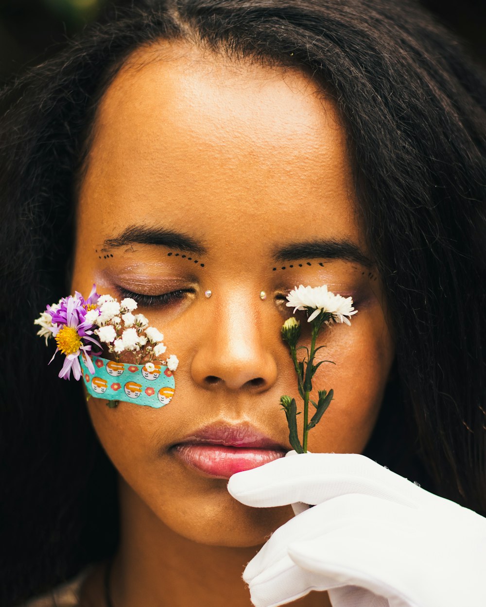 a woman with flowers painted on her face