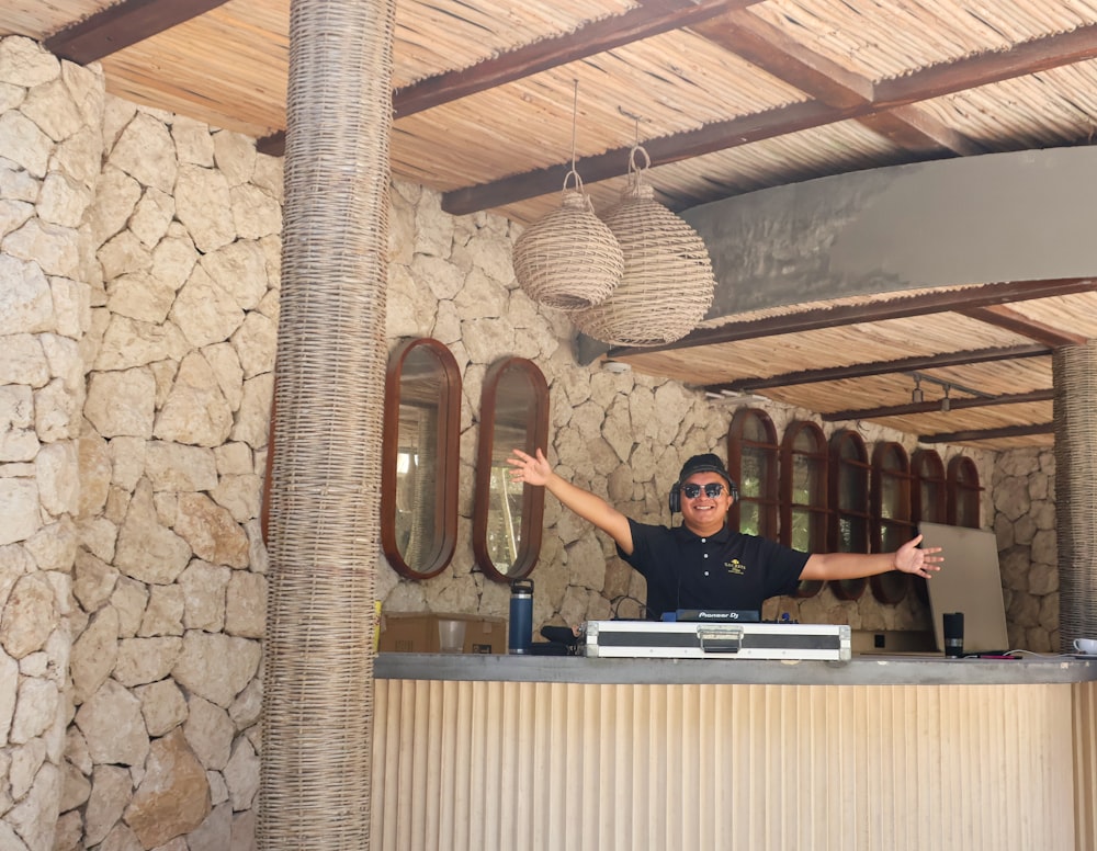 a man standing behind a counter in a restaurant