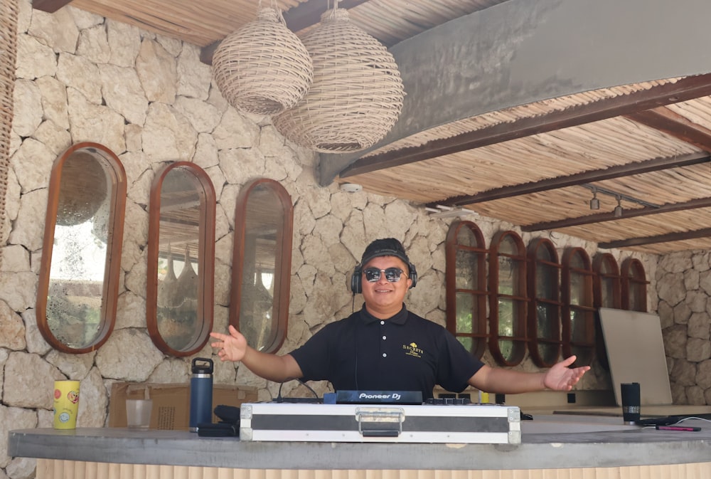 a man in a black shirt is behind a counter