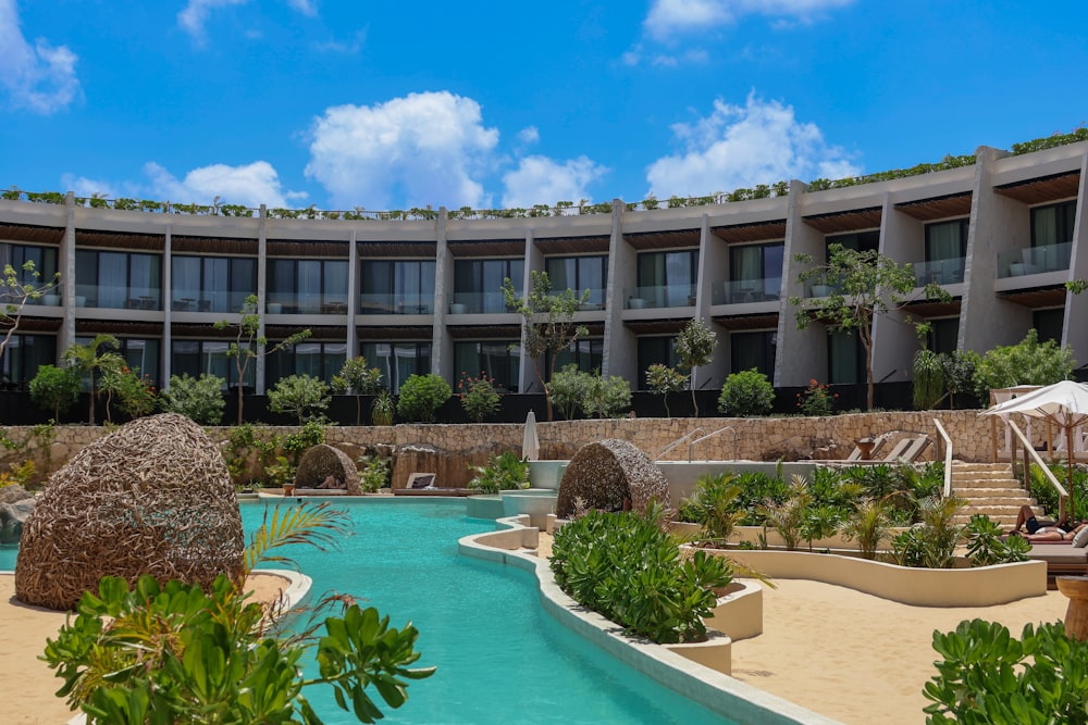 a large building with a pool in front of it