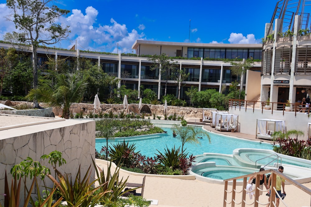 a large building with a pool in front of it