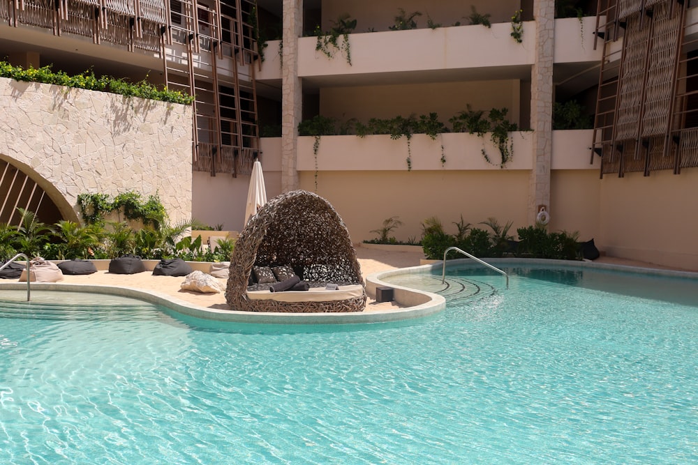 a large swimming pool with a fountain in the middle of it