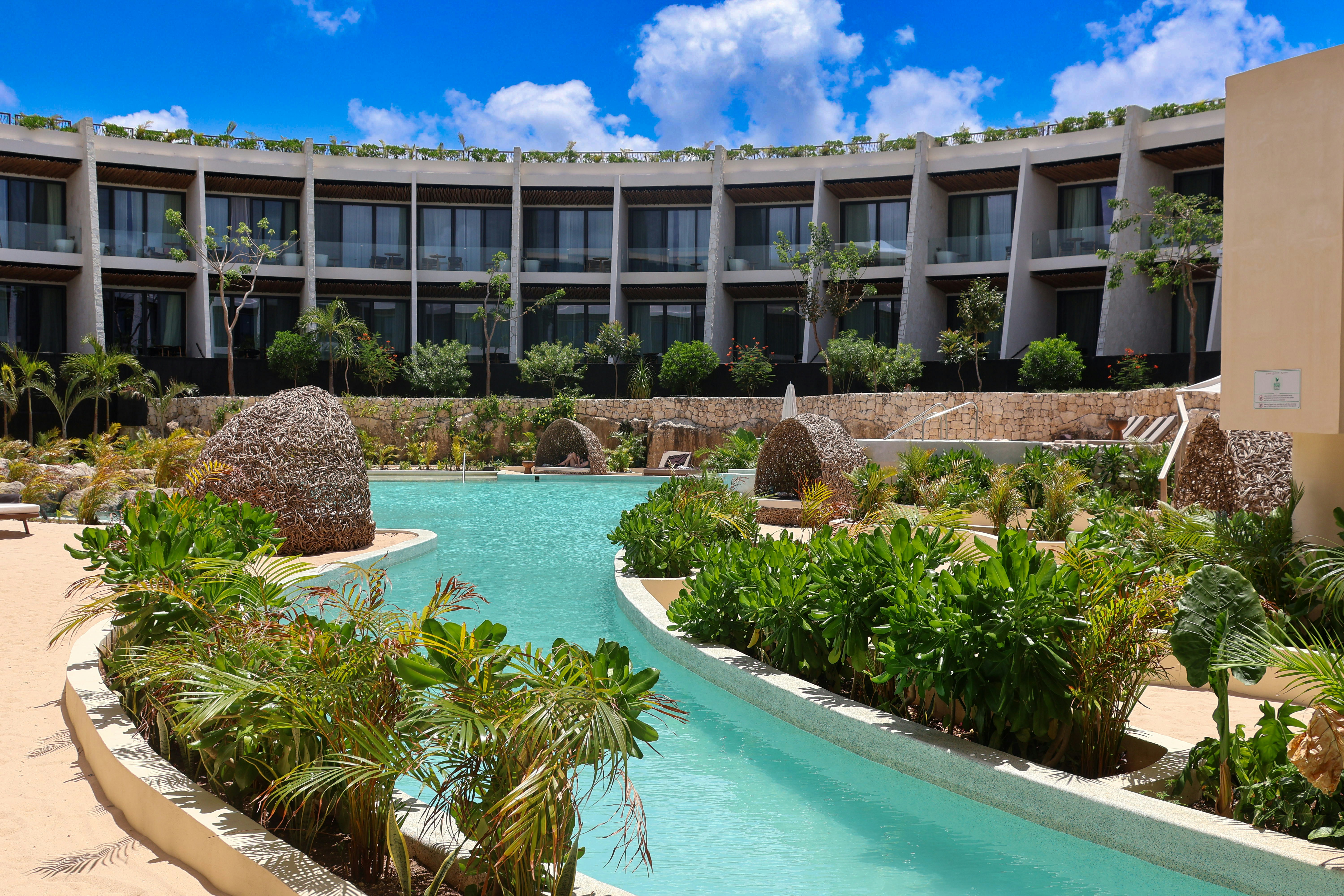 a large building with a pool in front of it, 