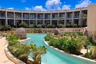 a large building with a pool in front of it