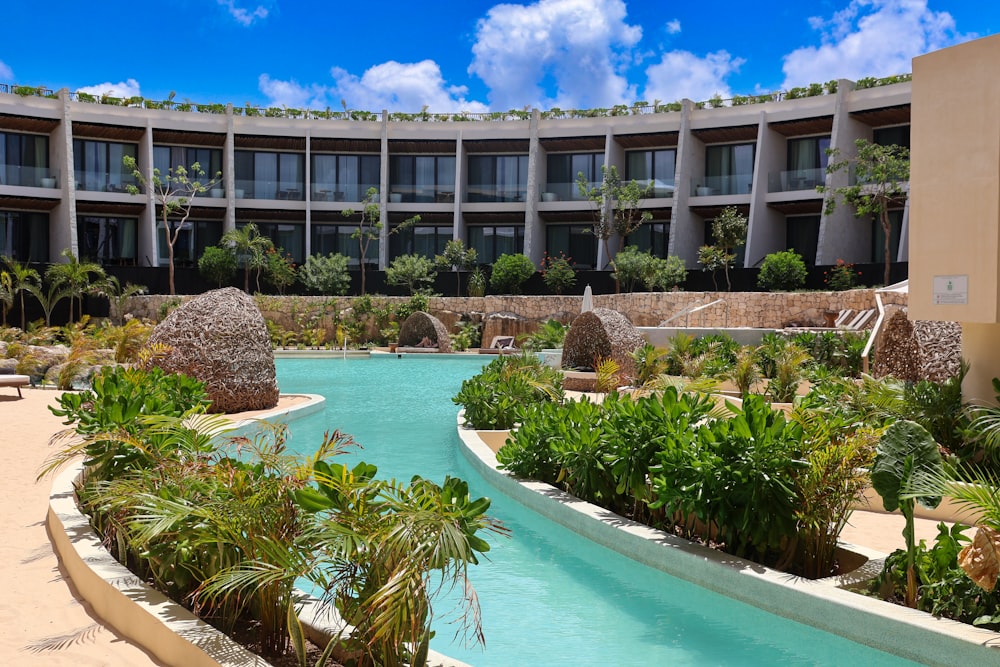 a large building with a pool in front of it