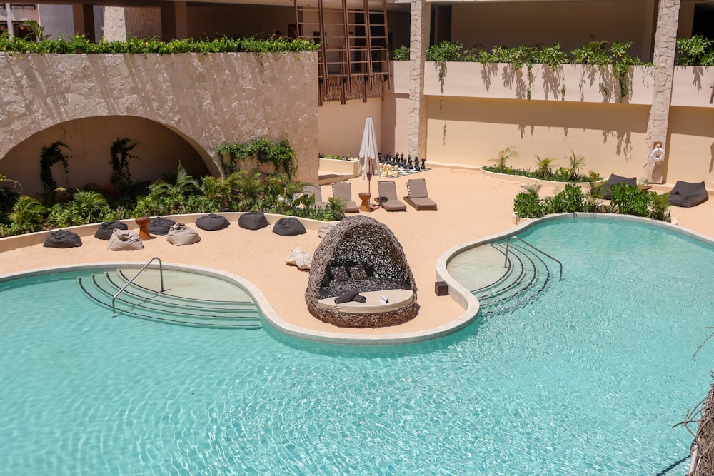 a pool with a rock in the middle of it