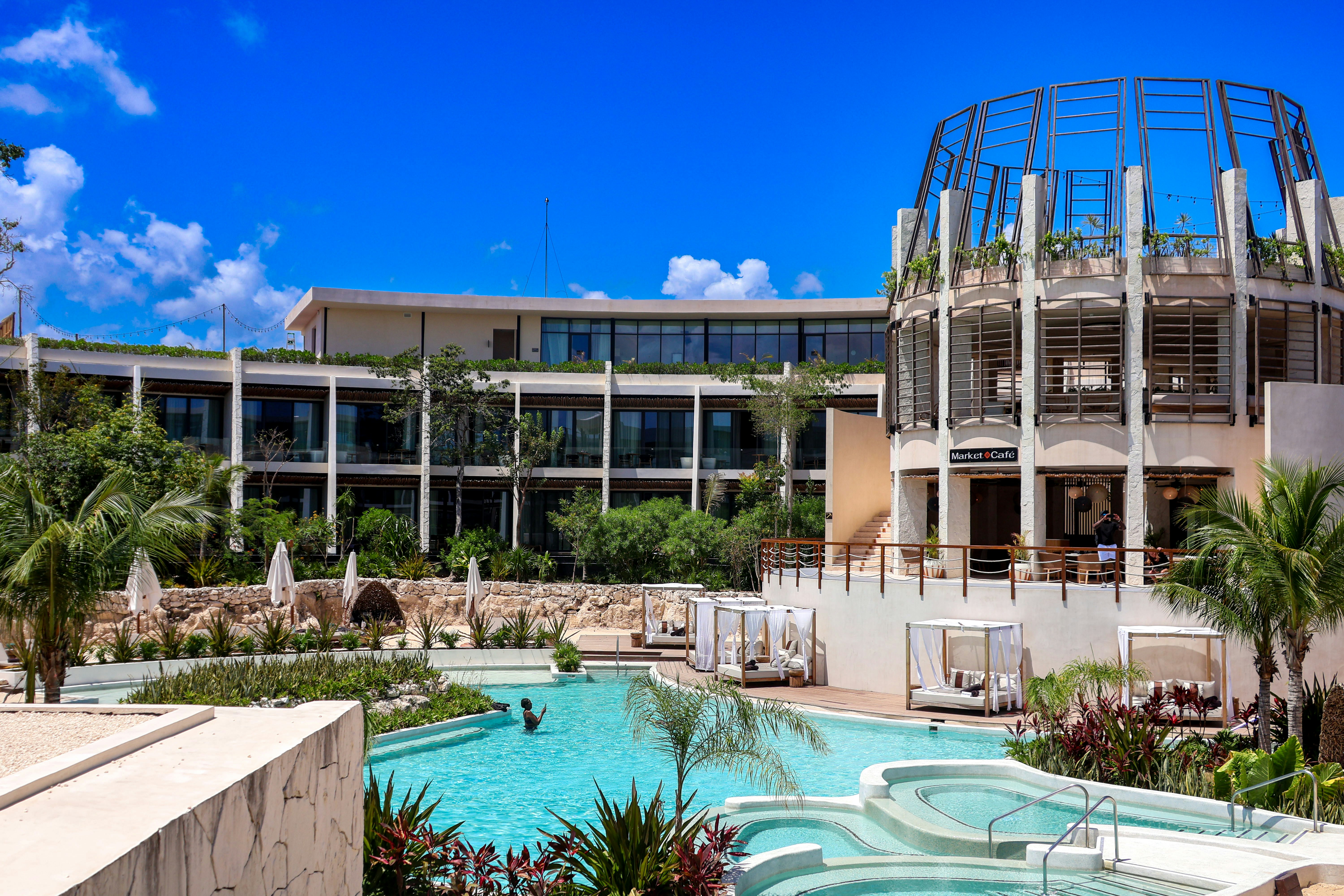 a large building with a pool in front of it, 