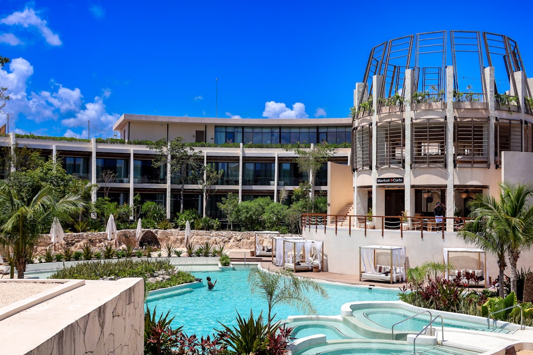 a large building with a pool in front of it,
