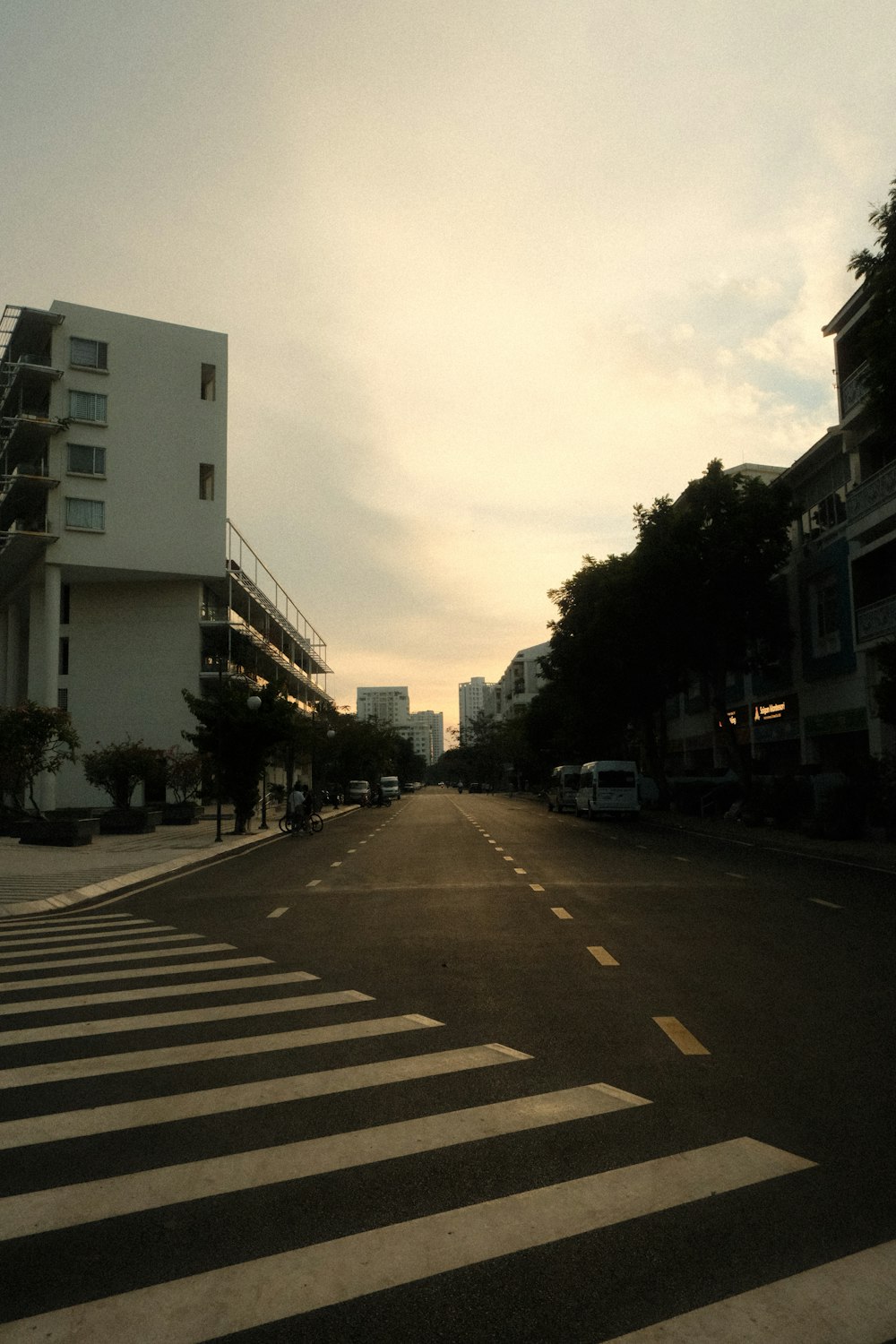 an empty street with a building in the background