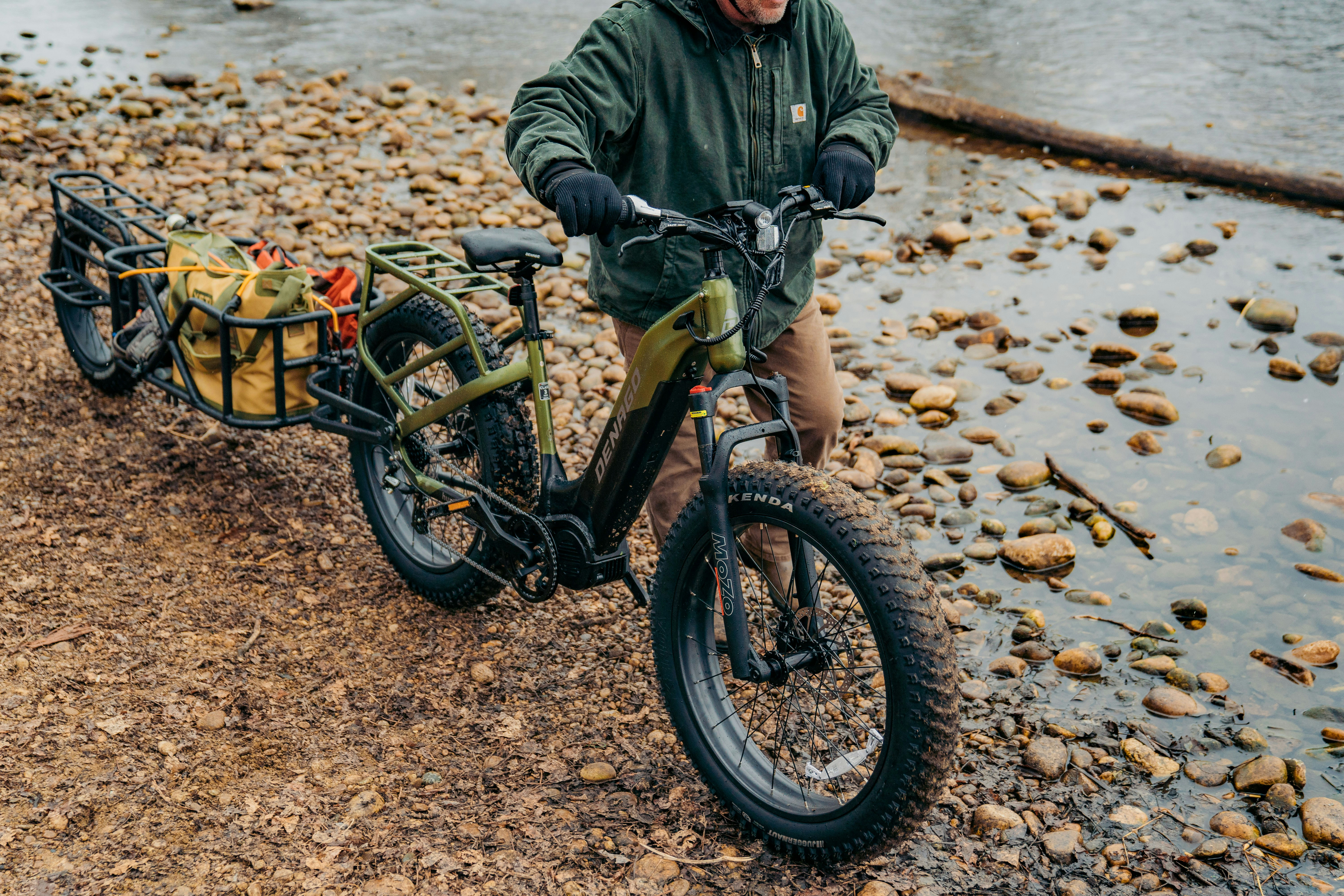 a man riding a bike next to a body of water