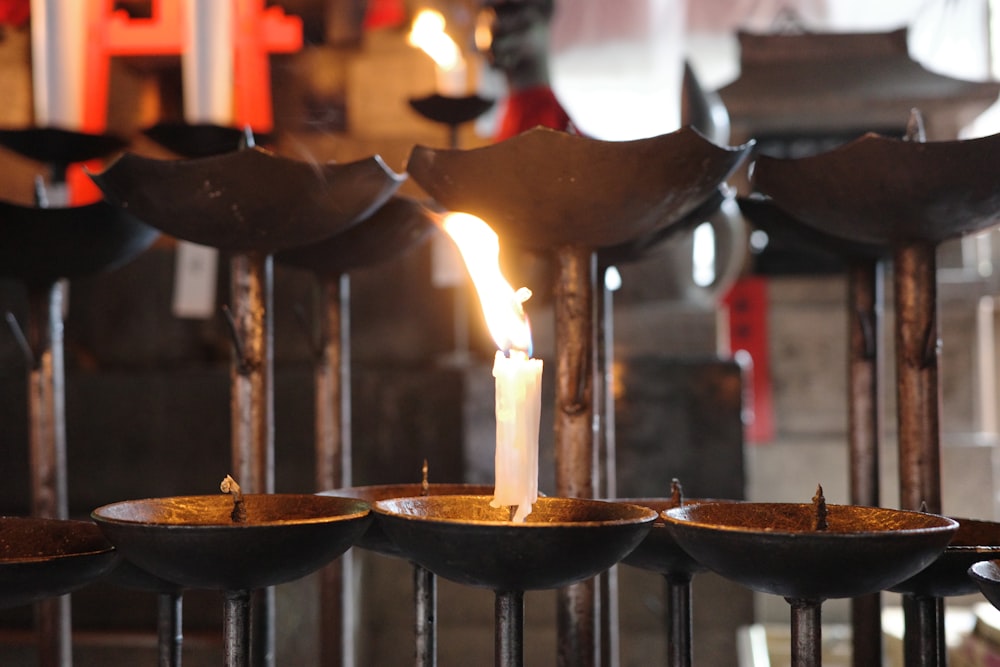 a candle is lit in a row of bowls