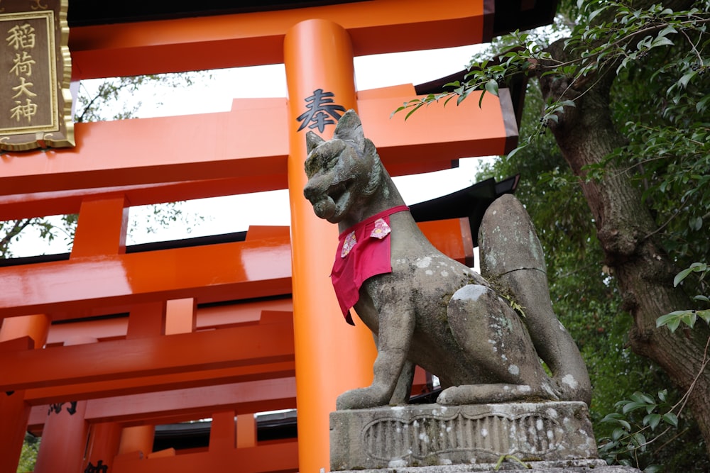 a statue of a dog wearing a pink shirt