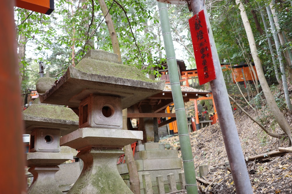 a group of stone lanterns in a forest