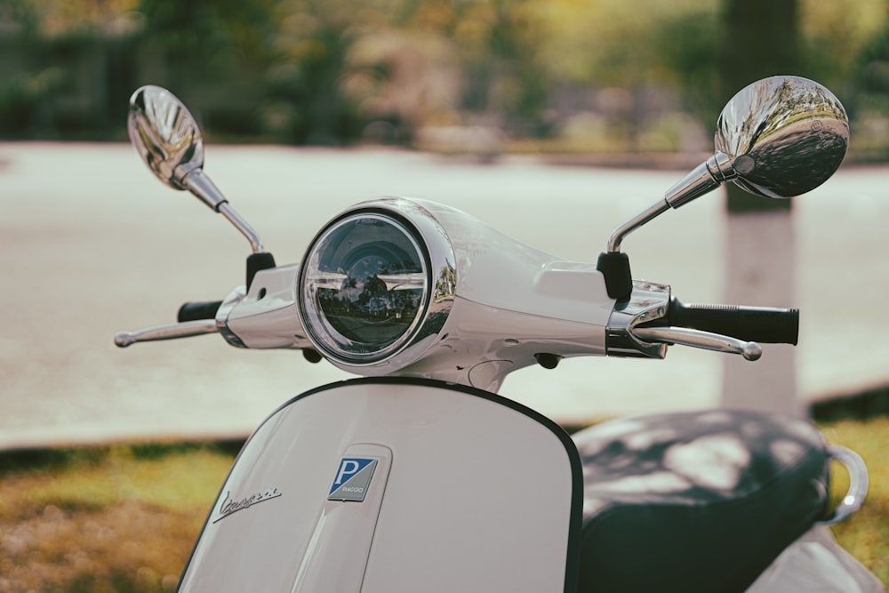 a white scooter parked on the side of the road