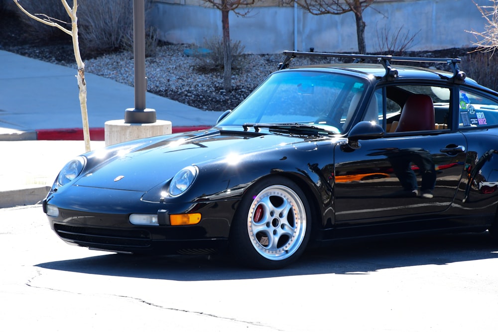 a black sports car parked on the side of the road