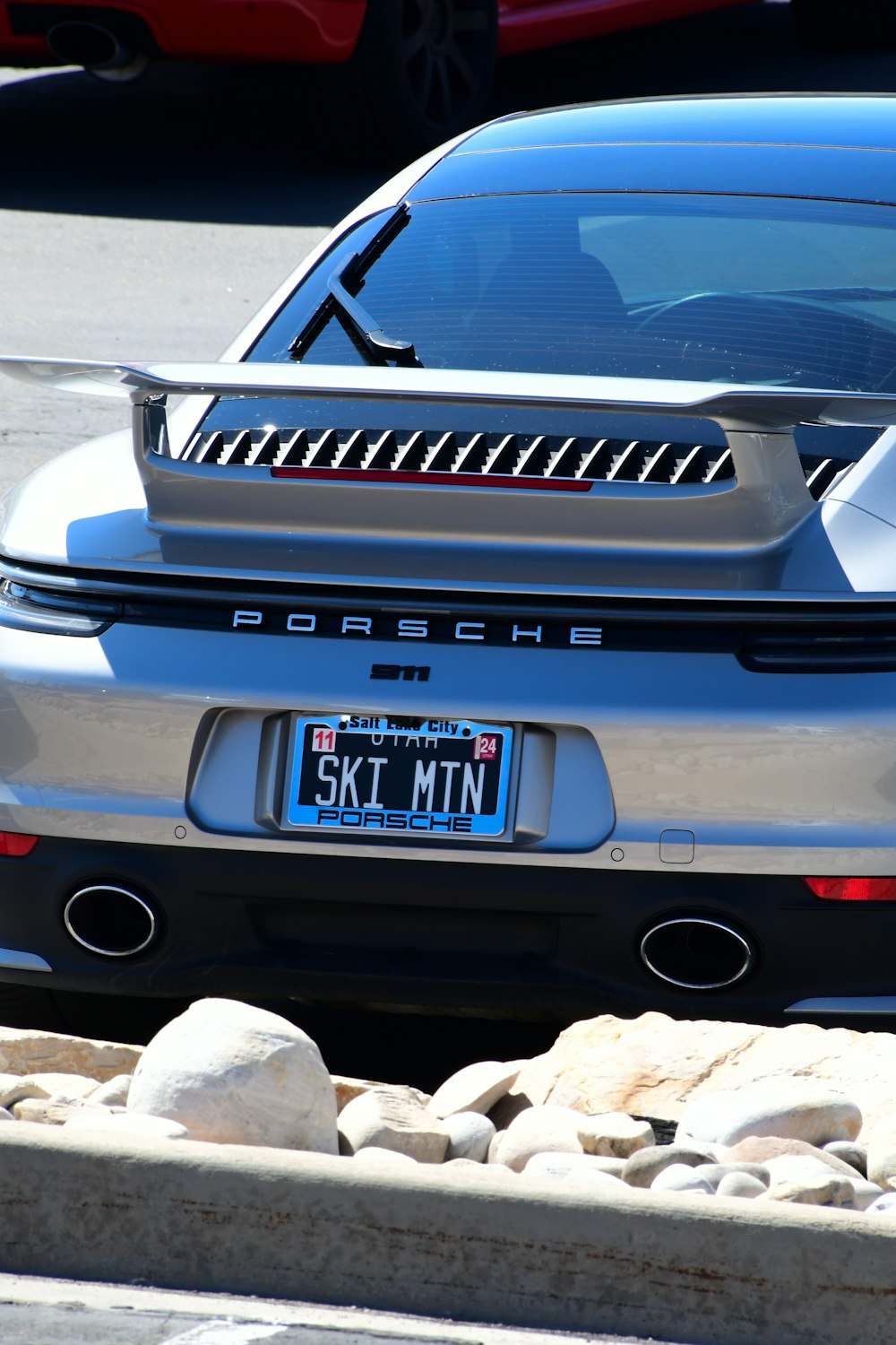 a silver sports car parked on the side of the road