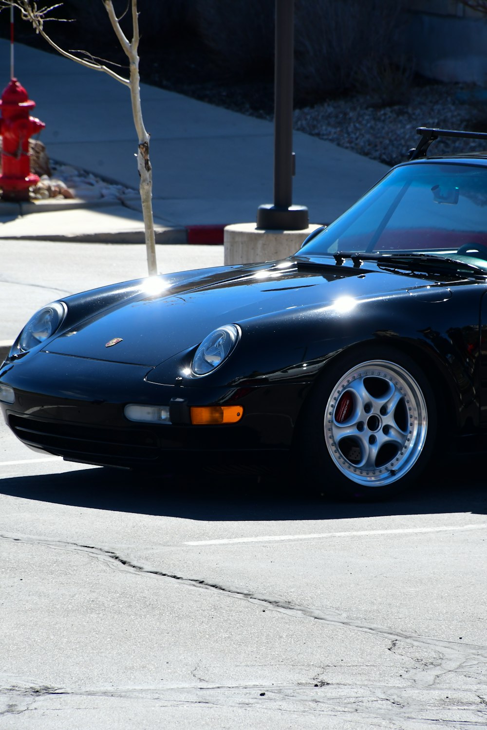 a black sports car parked on the side of the road