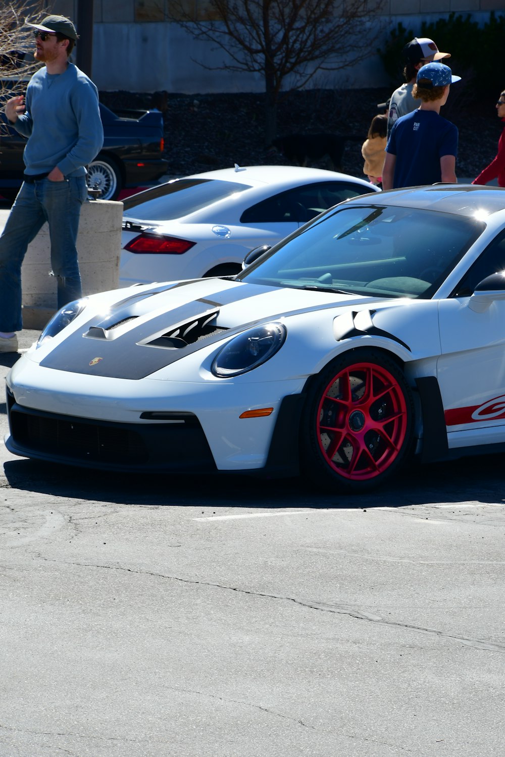 a white sports car parked in a parking lot