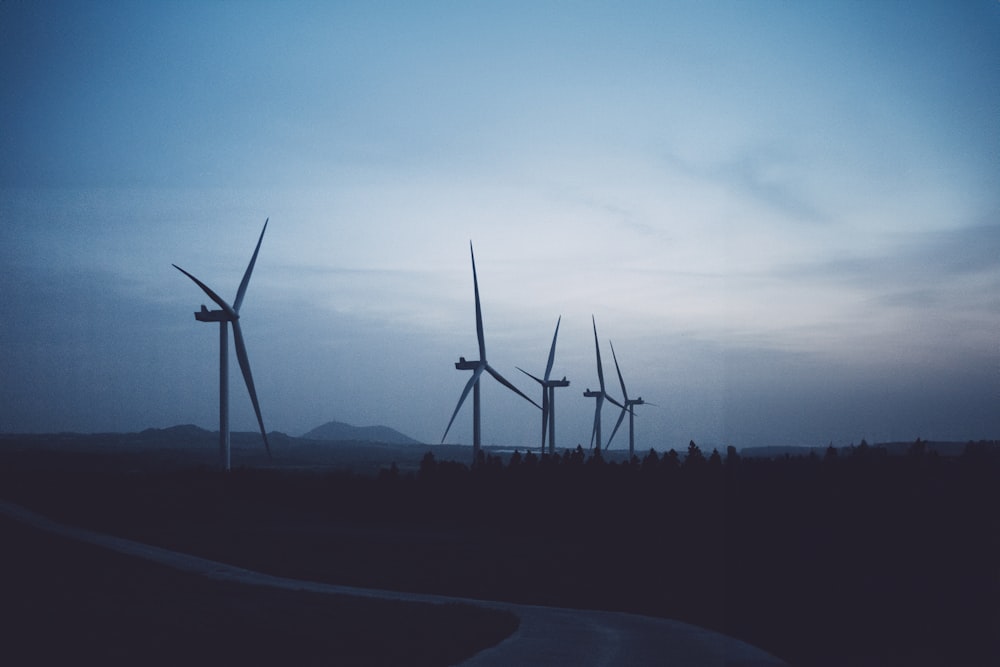 a group of wind turbines in a field