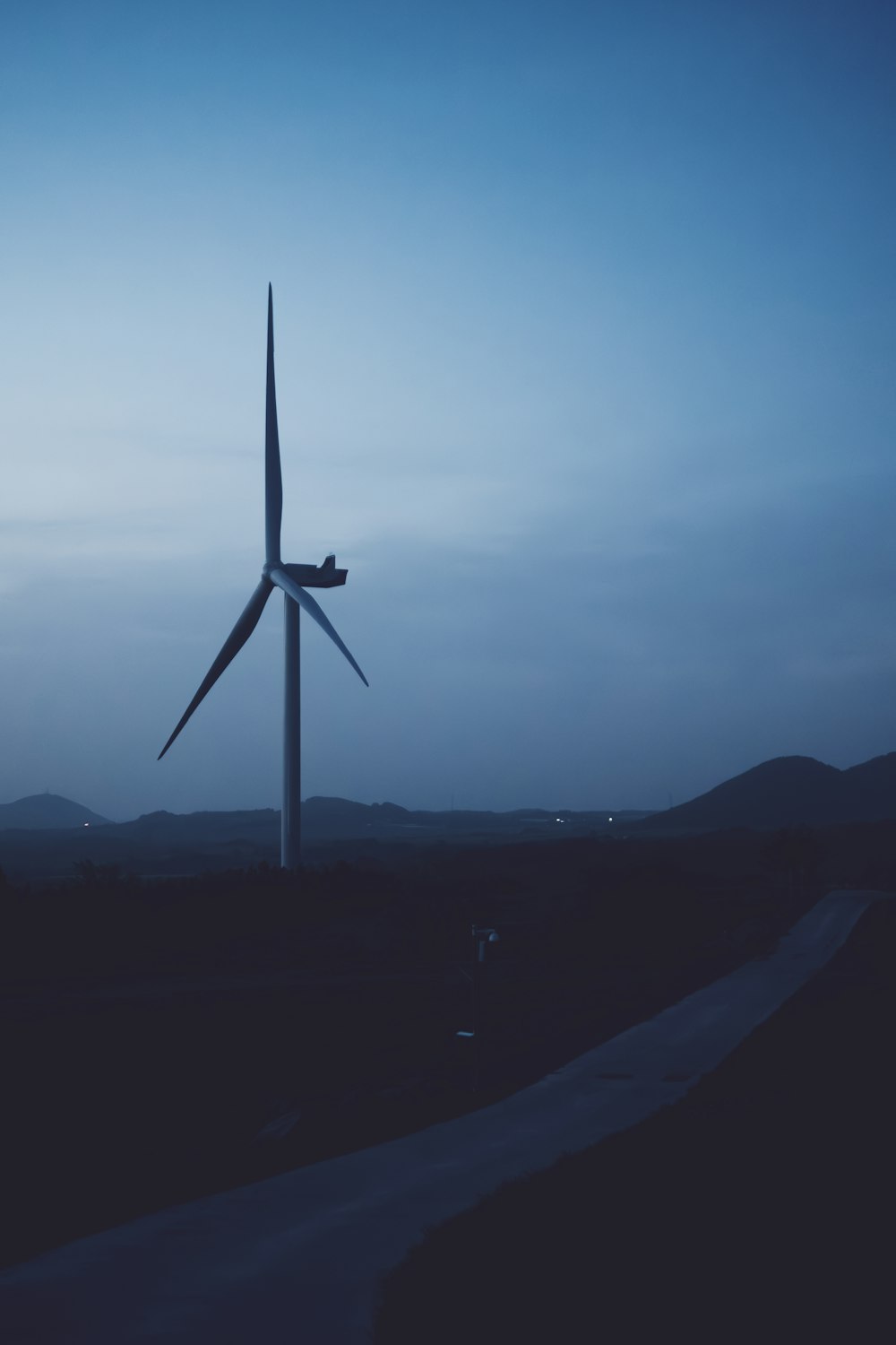 a wind turbine in the middle of a field