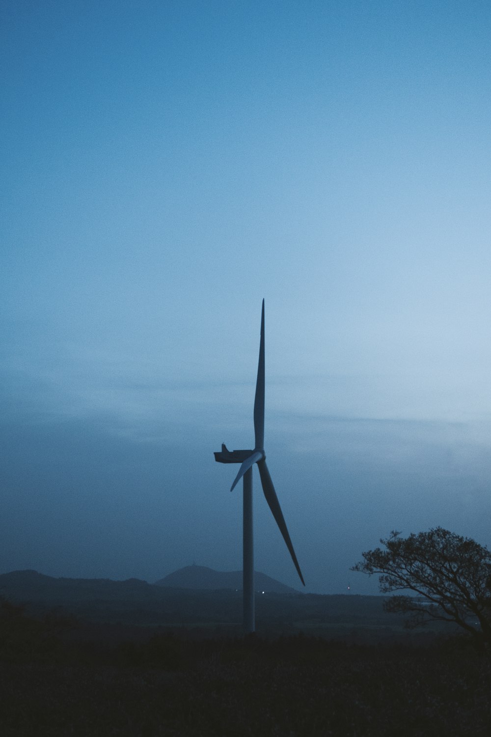 a wind turbine in the middle of a field