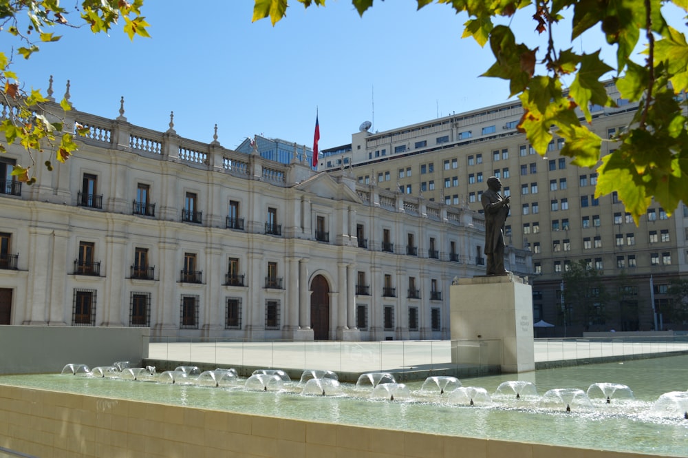 a large building with a fountain in front of it