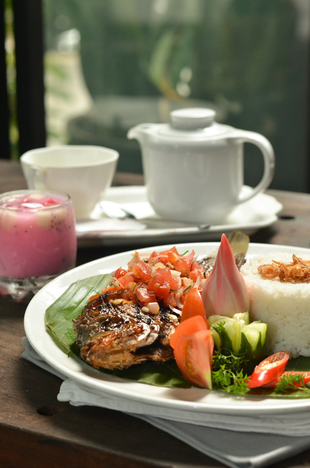 a white plate topped with meat and vegetables