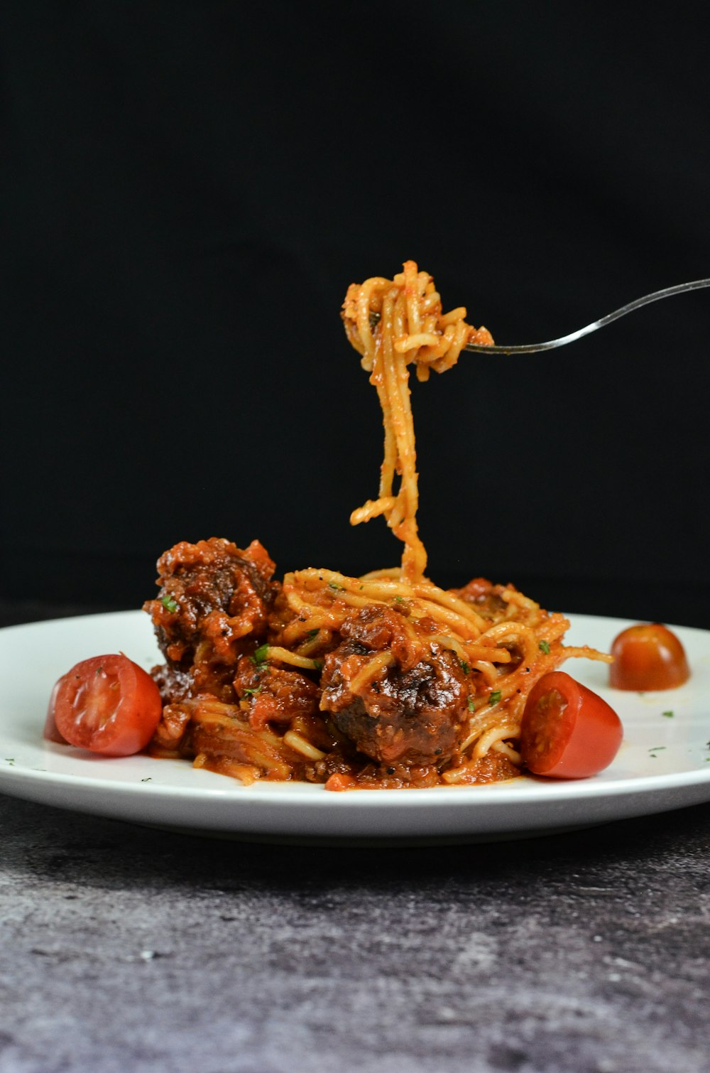 a white plate topped with spaghetti and meat
