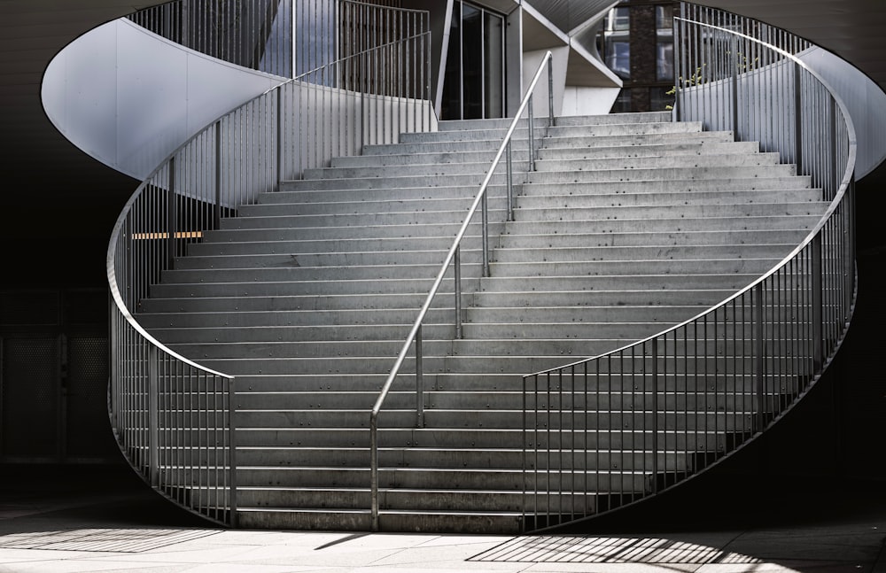 a spiral staircase in a building with metal railings